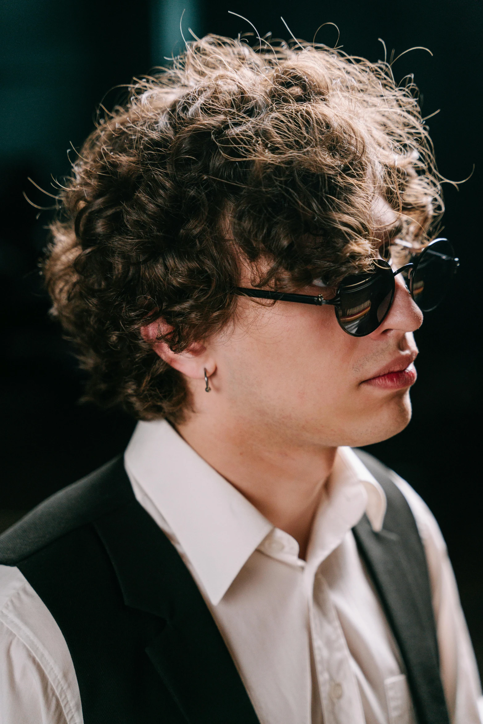 a young man wearing sunglasses and a vest, inspired by Michael Ray Charles, trending on pexels, renaissance, finn wolfhard, strong jawline, in a suit, highly microdetailed