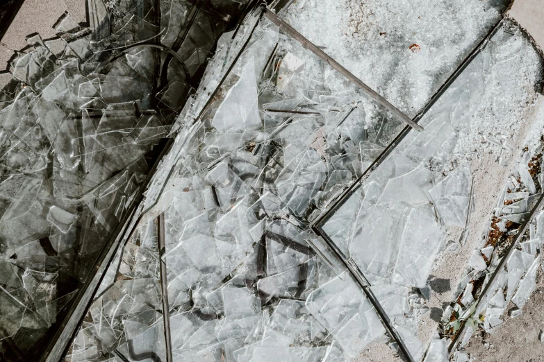 a broken piece of glass sitting on the ground, an album cover, inspired by Anselm Kiefer, trending on pexels, crystal cubism, background image, collapsed floors, industrial futuristic ice mine, high details photo