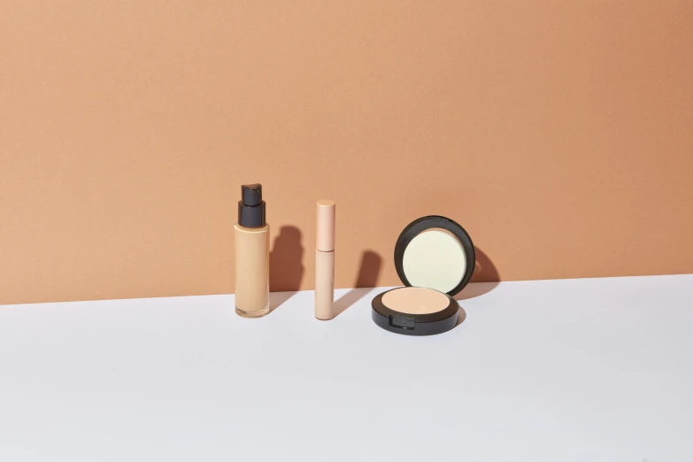 a couple of makeup products sitting on top of a table, a still life, inspired by Mac Conner, beige, uncompressed, product introduction photo