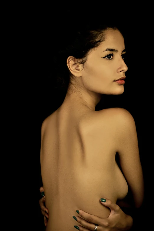 a naked woman standing in front of a black background, an album cover, inspired by Roberto Ferri, flickr, showing her shoulder from back, portrait of penelope cruz, 5 0 0 px models, photography hyperrealism