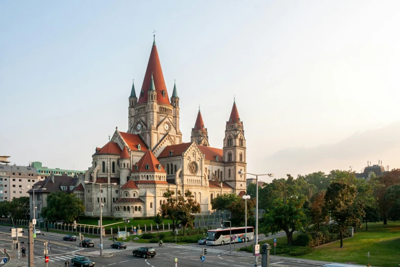 a large building sitting on the side of a road, inspired by Mihály Munkácsy, unsplash contest winner, art nouveau, church cathedral, austro - hungarian, evening light, panorama view