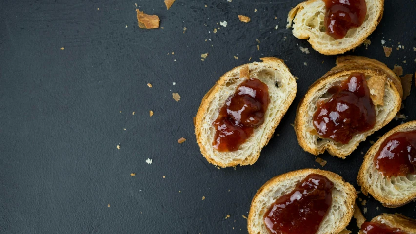 a bunch of toasted bread with jam on it, a portrait, inspired by Richmond Barthé, pexels, on a gray background, extra ketchup, background image, maintenance photo