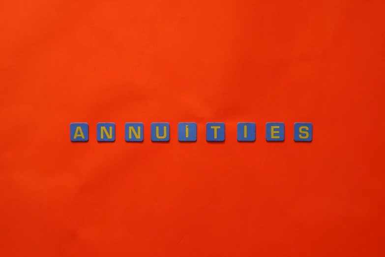 the word annuities spelled in blue letters on an orange background, an album cover, pexels contest winner, vanitas, legos, still from a wes anderson film, blue and red two - tone, annie leibowit