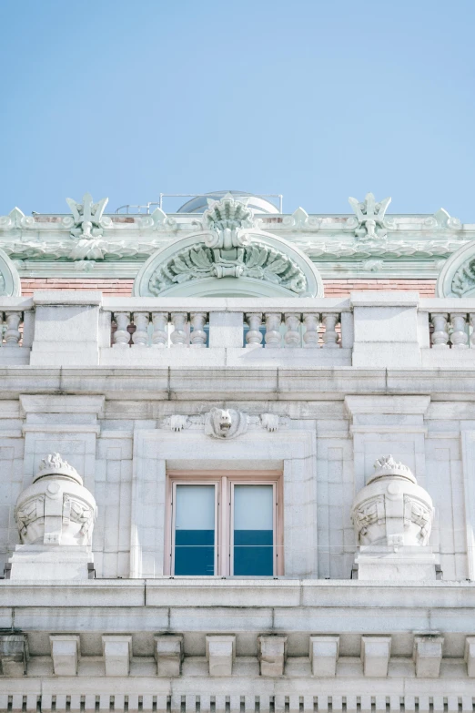a large building with a clock on top of it, a marble sculpture, inspired by Wes Anderson, trending on unsplash, intricate detailed roof, view of the ocean, library of congress, aquamarine windows