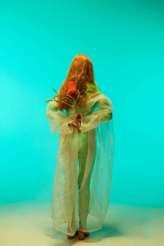 a woman standing in front of a green background, an album cover, inspired by Elsa Bleda, conceptual art, corpse bridegroom of the spring, plastic doll, showstudio, long flowing hair underwater