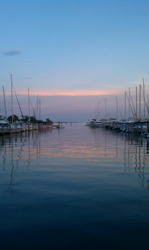 a large body of water filled with lots of boats, by Pamela Drew, pexels contest winner, soft glow, upon a peak in darien, phone photo, naples