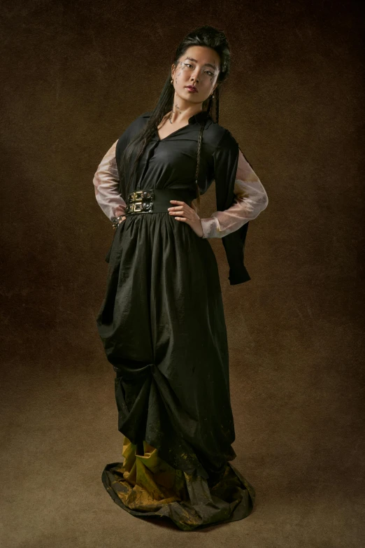 a woman in a black dress posing for a picture, inspired by Artemisia Gentileschi, renaissance, stylised military clothes, tom chambers photography, middle eastern, taken in the early 2020s