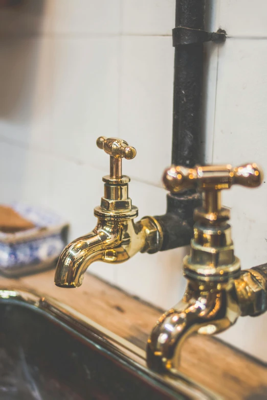 a close up of a kitchen sink with a faucet, a still life, unsplash, renaissance, gold pipelines, tattooed, manufactured in the 1920s, levers