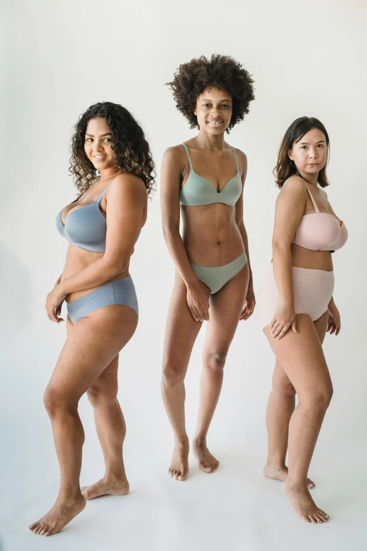 a group of women standing next to each other, soft curvy shape, product shot, various colors, 3 - piece