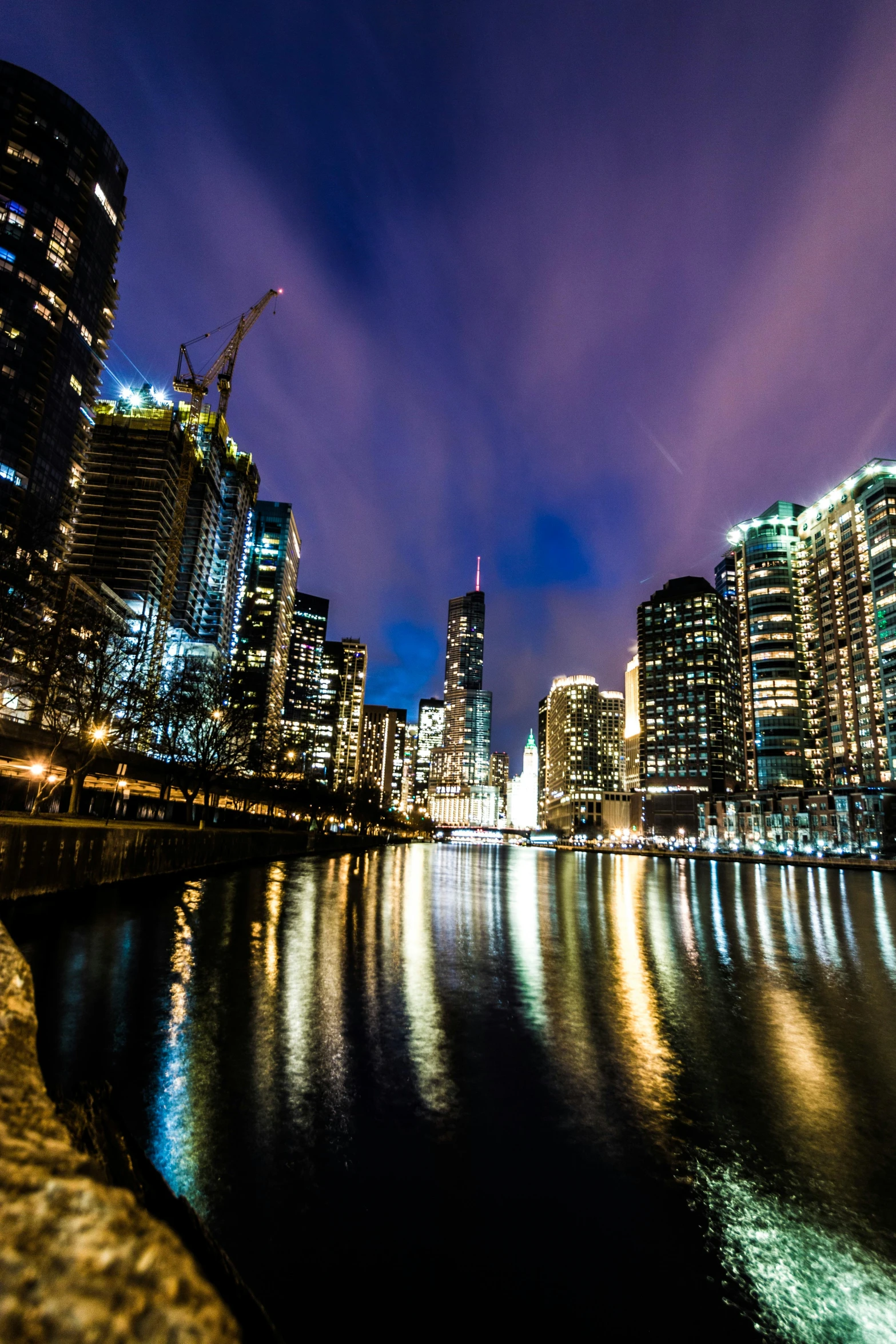 a large body of water surrounded by tall buildings, by Greg Rutkowski, pexels contest winner, river gorgeous lighting, trump tower, iso 1 0 0 wide view, cold lighting