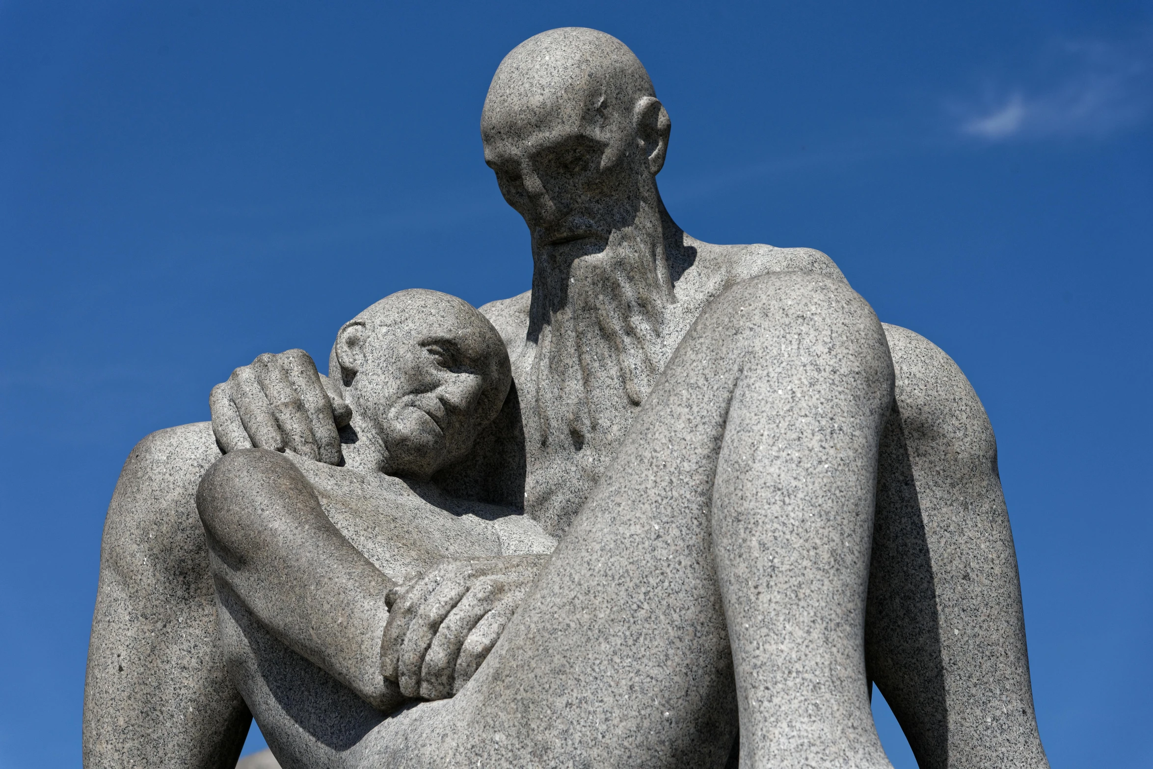 a statue of a man holding a baby, by karlkka, unsplash, mannerism, hugging his knees, bald man, kalevala, 🚿🗝📝