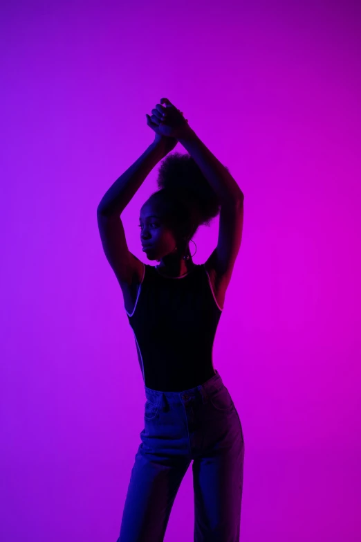 a woman standing in front of a purple background, by Tom Bonson, pexels, pink and blue lighting, modern dance aesthetic, black young woman, back light