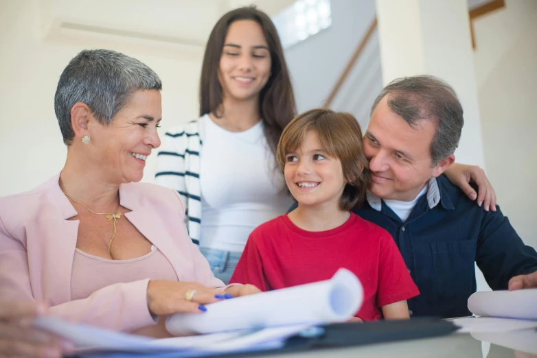 a family sitting at a table looking at paperwork, fantastic realism, 15081959 21121991 01012000 4k, health supporter, for junior, high-quality photo