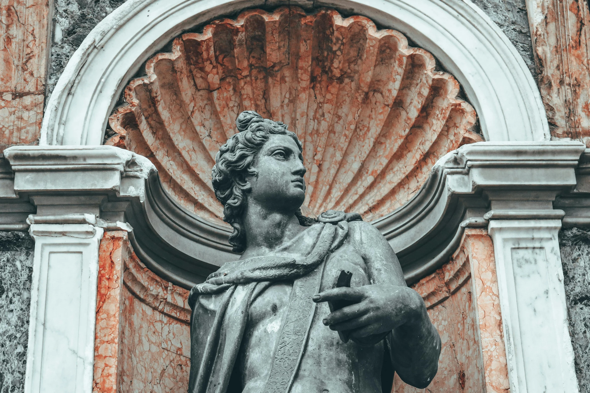 a black and white photo of a statue of a man, a statue, inspired by Giovanni Battista Innocenzo Colombo, pexels contest winner, payne's grey and venetian red, colonnade, brown, album cover