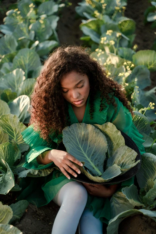 a woman sitting in a field of cabbage, by Jessie Algie, pexels contest winner, renaissance, black young woman, serena williams, with ivy, an island made of food