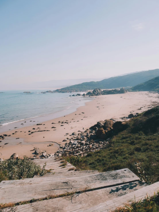 a view of a beach from the top of a hill, inspired by Almada Negreiros, unsplash, poor quality, 2 5 6 x 2 5 6 pixels, elegant pose, australian beach