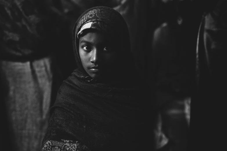 a black and white photo of a young girl, unsplash contest winner, hurufiyya, wrapped in a black scarf, bangladesh, 🤤 girl portrait, brown skinned