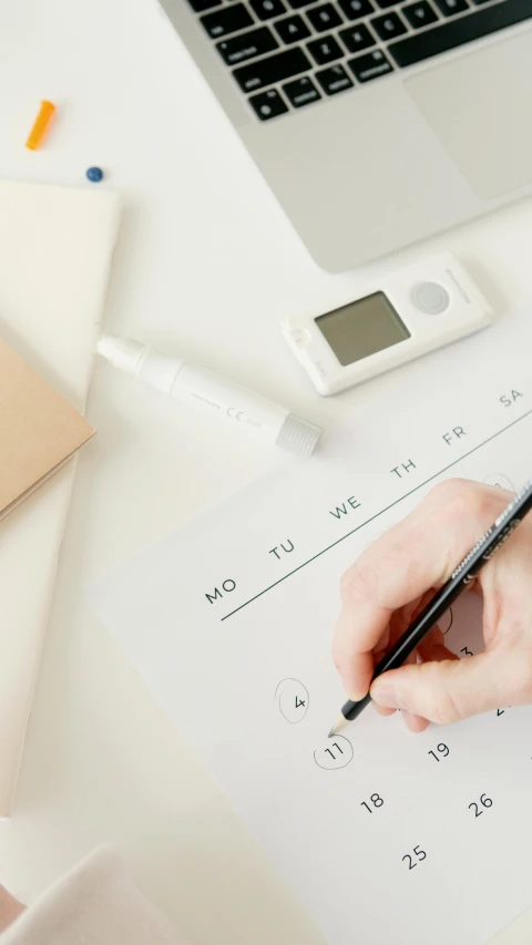 a person writing on a piece of paper next to a laptop, trending on pexels, knolling, educational supplies, white, healthcare