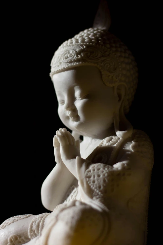 a close up of a statue of a child, a marble sculpture, inspired by Zhang Zeduan, praying meditating, porcelain, karma sutra, nighttime