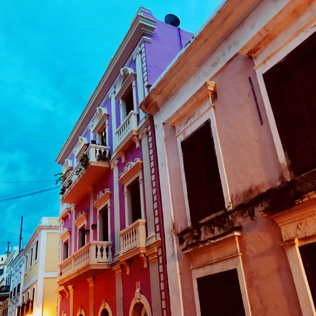 a couple of buildings that are next to each other, a photo, by Gina Pellón, pexels contest winner, renaissance, purple and pink, puerto rico, prussian blue and venetian red, square