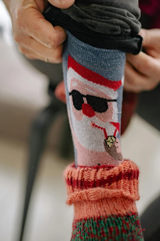 a close up of a person holding a sock, a picture, with sunglasses, sitting on santa, subtle detailing, f / 1 6