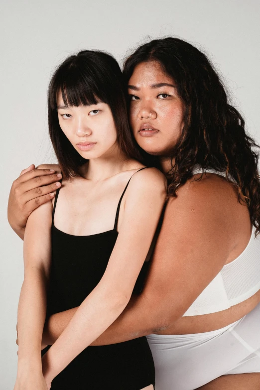 a couple of women standing next to each other, inspired by Wang Duo, intimately holding close, varying ethnicities, modelling, whitebangs