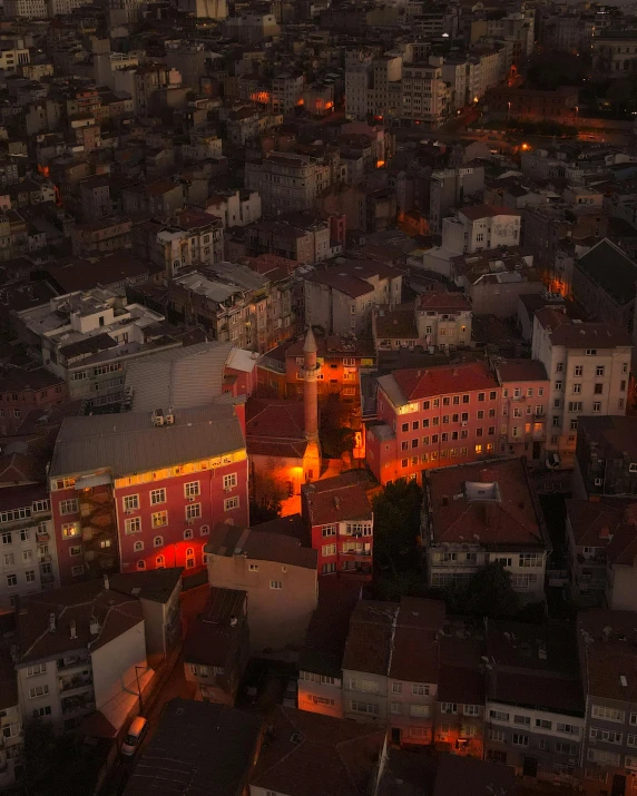 an aerial view of a city at night, an album cover, by Kristian Kreković, pexels contest winner, renaissance, red building, late afternoon lighting, gif, square