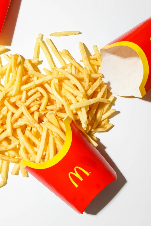 a pile of french fries sitting on top of a table, eating inside mcdonalds, set against a white background, promo photo, mac