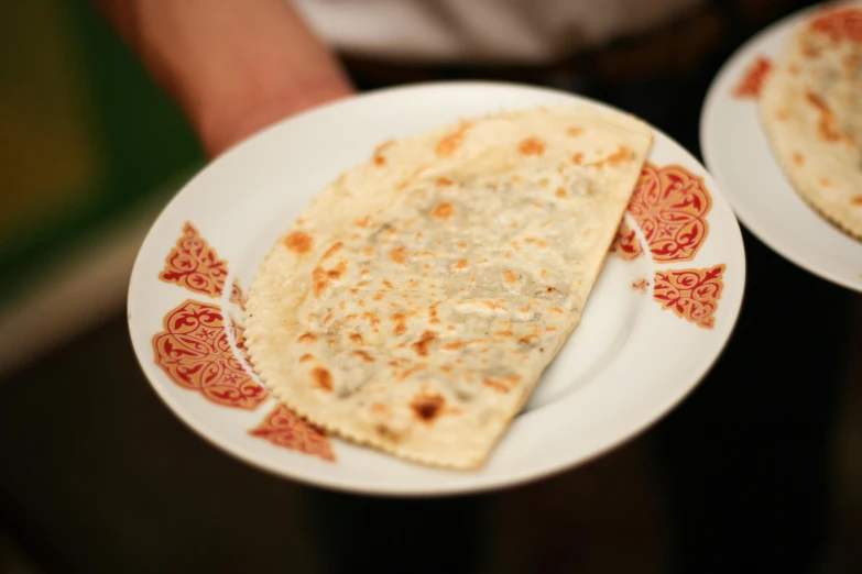 a close up of two plates of food on a table, inspired by Géza Dósa, hurufiyya, flat pancake head, wedding, romanian, white