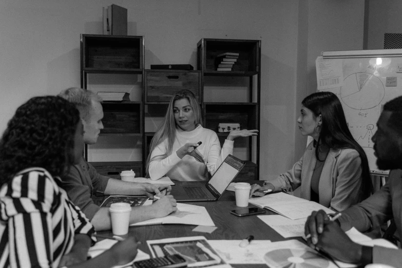 a group of women sitting around a wooden table, a black and white photo, pexels contest winner, working in an office, promo image, vp of marketing, nuri iyem