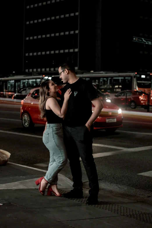 a man and woman standing on a city street at night, by Alejandro Obregón, pexels contest winner, square, flirty, standing in road, 15081959 21121991 01012000 4k