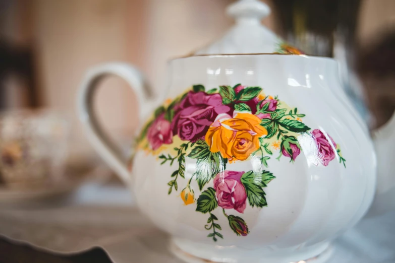 a close up of a tea pot on a table, pexels contest winner, royally decorated, rose twining, multicoloured, thumbnail