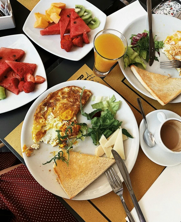 a table topped with plates of food and a cup of coffee, eggs, thumbnail, fruit, square