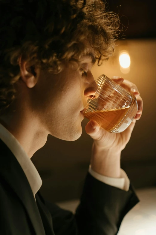 a man in a suit drinking from a glass, unsplash, renaissance, whisky, blonde man, joe keery, dynamic closeup