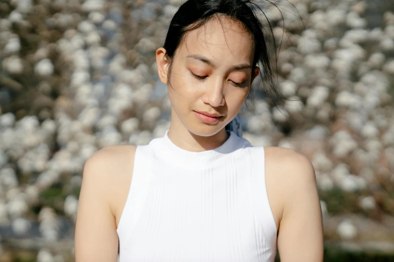 a woman looking down at her cell phone, inspired by Kim Tschang Yeul, trending on pexels, shin hanga, wearing white leotard, peaceful face, sydney park, portrait image