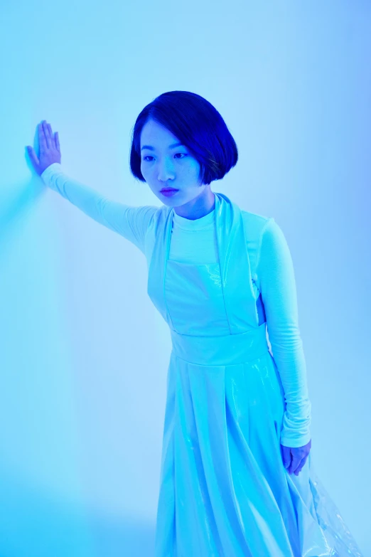 a woman in a blue dress posing for a picture, an album cover, inspired by Gao Cen, kiyoko suzuki, ((blue)), fluorescent, white sky