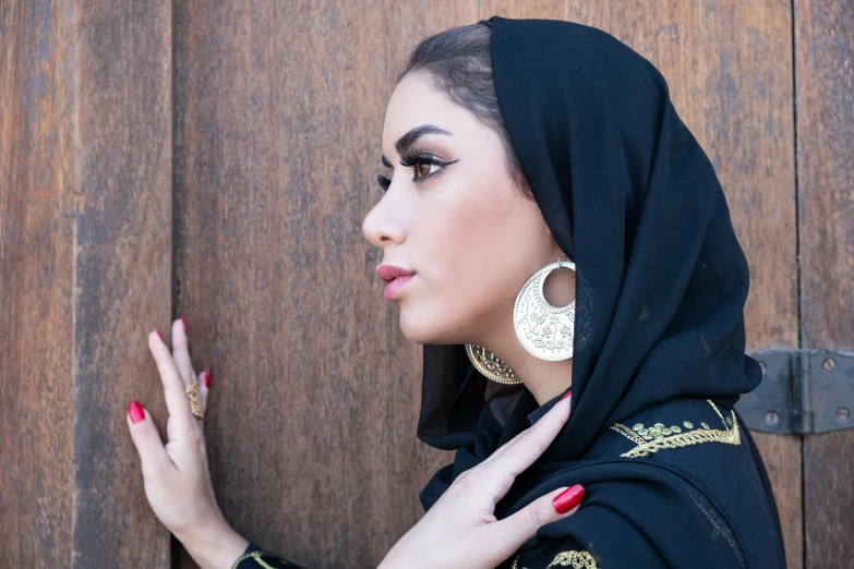 a beautiful young woman wearing a black hijab, pexels contest winner, arabesque, giant earrings, 15081959 21121991 01012000 4k, woman in streetwear, wearing an elegant tribal outfit