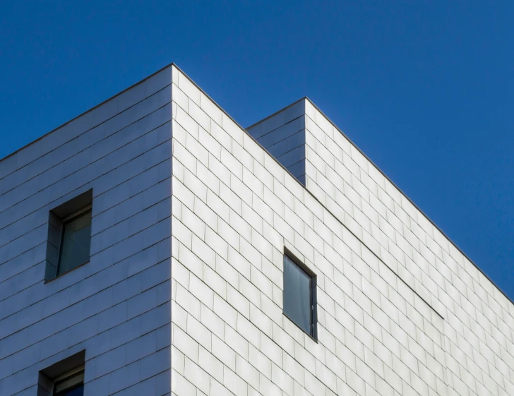 a clock that is on the side of a building, an album cover, inspired by Bauhaus, unsplash, bauhaus, clear blue skies, tiles, galvalume metal roofing, square jaw-line