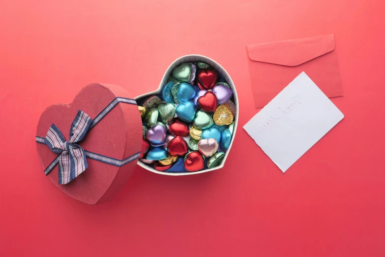 a heart shaped box filled with assorted chocolates, a still life, by Valentine Hugo, pexels contest winner, hurufiyya, red and blue, paper, multicoloured, thumbnail