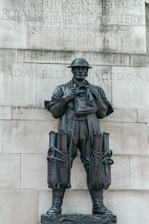 a statue of a man standing in front of a wall, door gunner, in london, tom morello, frederick bacon