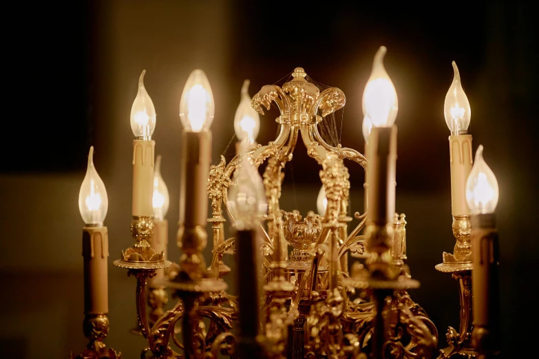 a close up of a chandelier with many lit candles, inspired by Elsa Bleda, pexels, baroque, gold plated, intricate 8 k detail, kris kuksi, magicavoxel cinematic lighting