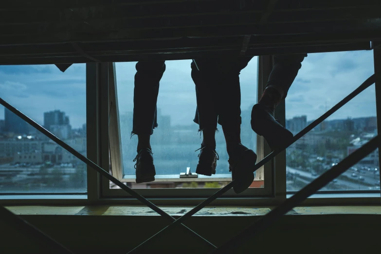a couple of people standing on top of a window sill, inspired by Elsa Bleda, pexels contest winner, scaffolding collapsing, detailed legs looming over you, worksafe. instagram photo, crawling out of a dark room