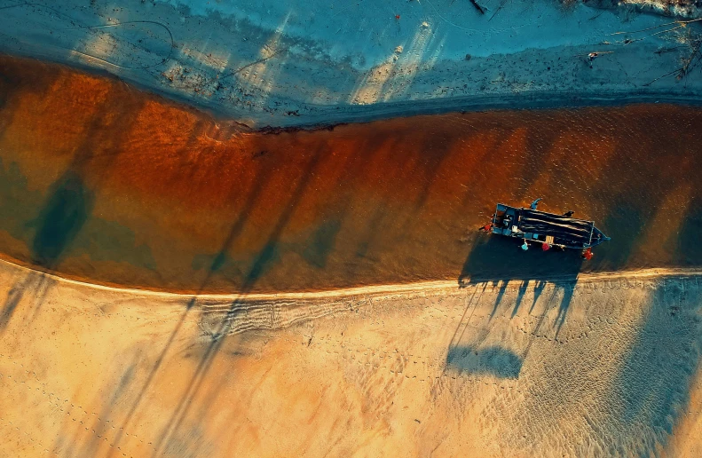 a truck driving down a dirt road next to a body of water, by Daniel Lieske, pexels contest winner, conceptual art, brown red blue, close-up from above, oilfield scene, gif