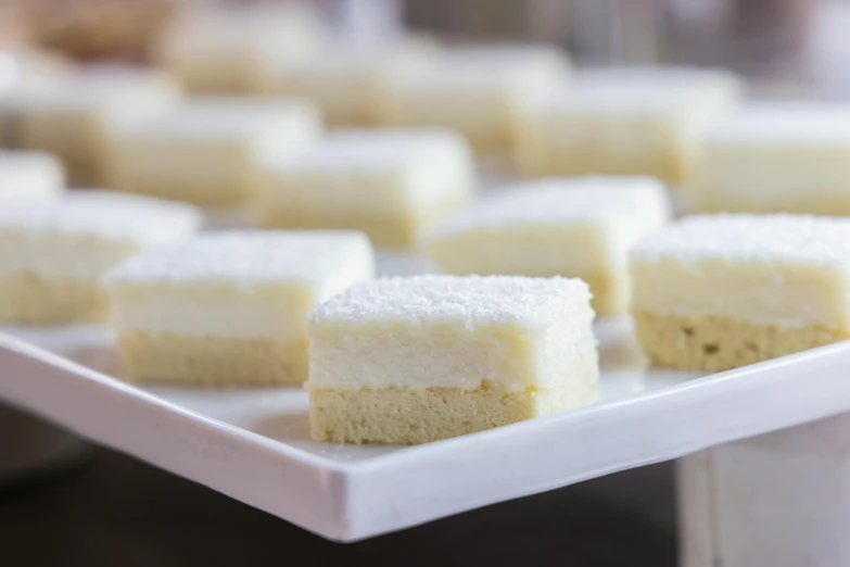 a close up of a plate of food on a table, eating cakes, square, frosted, fan favorite