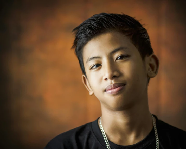 a young man with a chain around his neck, by Matthias Stom, pexels contest winner, sumatraism, portrait of 14 years old boy, portrait of modern darna, slightly tanned, vocalist