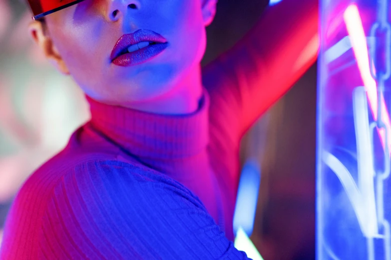 a woman standing in front of a neon light, by Adam Marczyński, blue lips, details and vivid colors, night club, red and blue