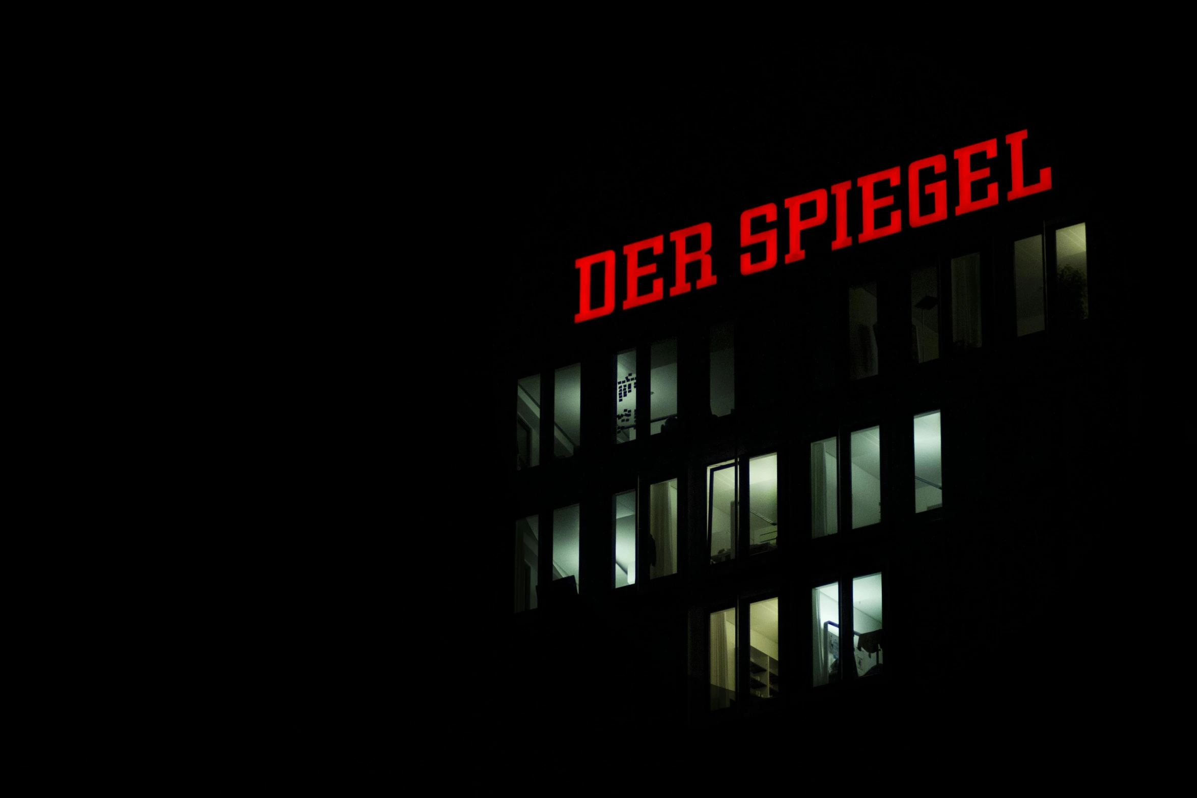 a clock on the side of a building at night, an album cover, inspired by Siegfried Haas, berlin secession, dren from splice, spiel des jahres, red leds, top secret