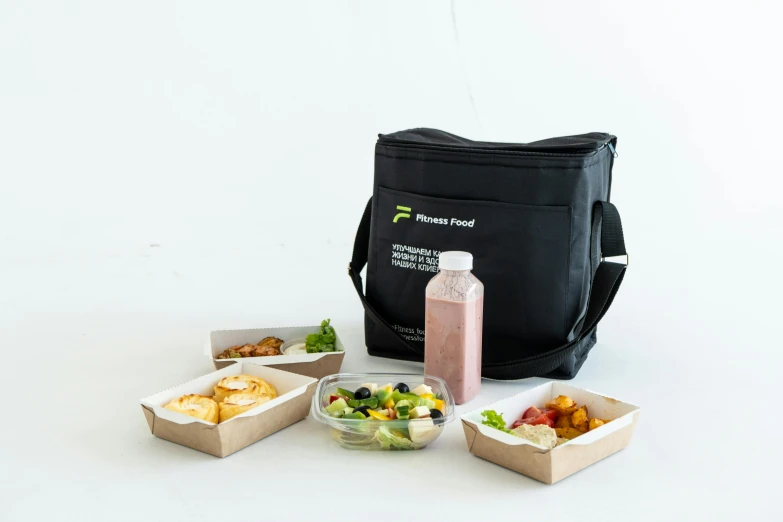 a lunch bag sitting on top of a table, bowl filled with food, product image, sydney, white background and fill