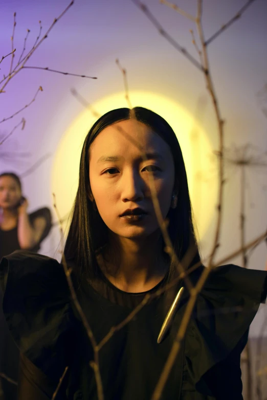 a woman standing in front of a group of people, an album cover, inspired by Kim Tschang Yeul, unsplash, conceptual art, npc with a saint's halo, moon behind, jingna zhang, performance