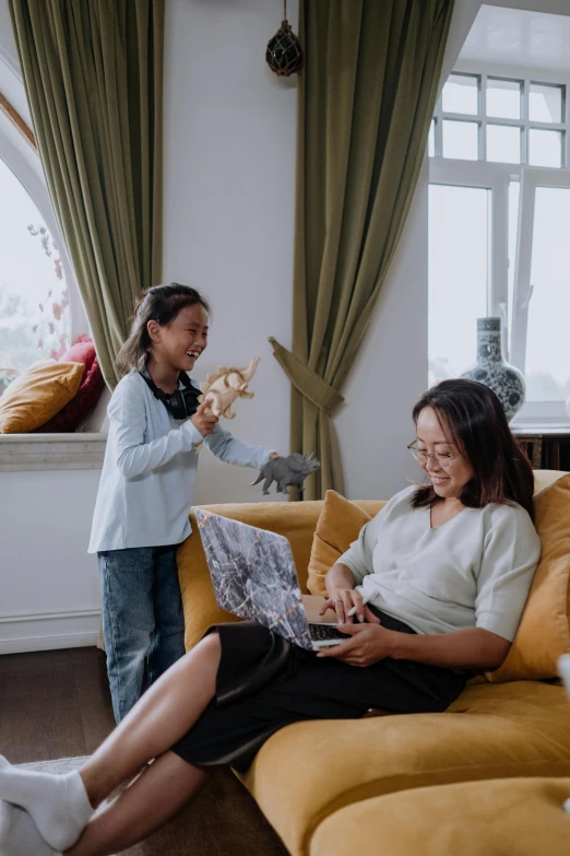 a couple of women sitting on top of a couch, inspired by Ruth Jên, pexels contest winner, the woman holds more toys, architect, young asian girl, families playing